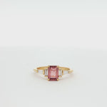 360 video of a peachy pink sapphire engagement ring with diamonds spinning