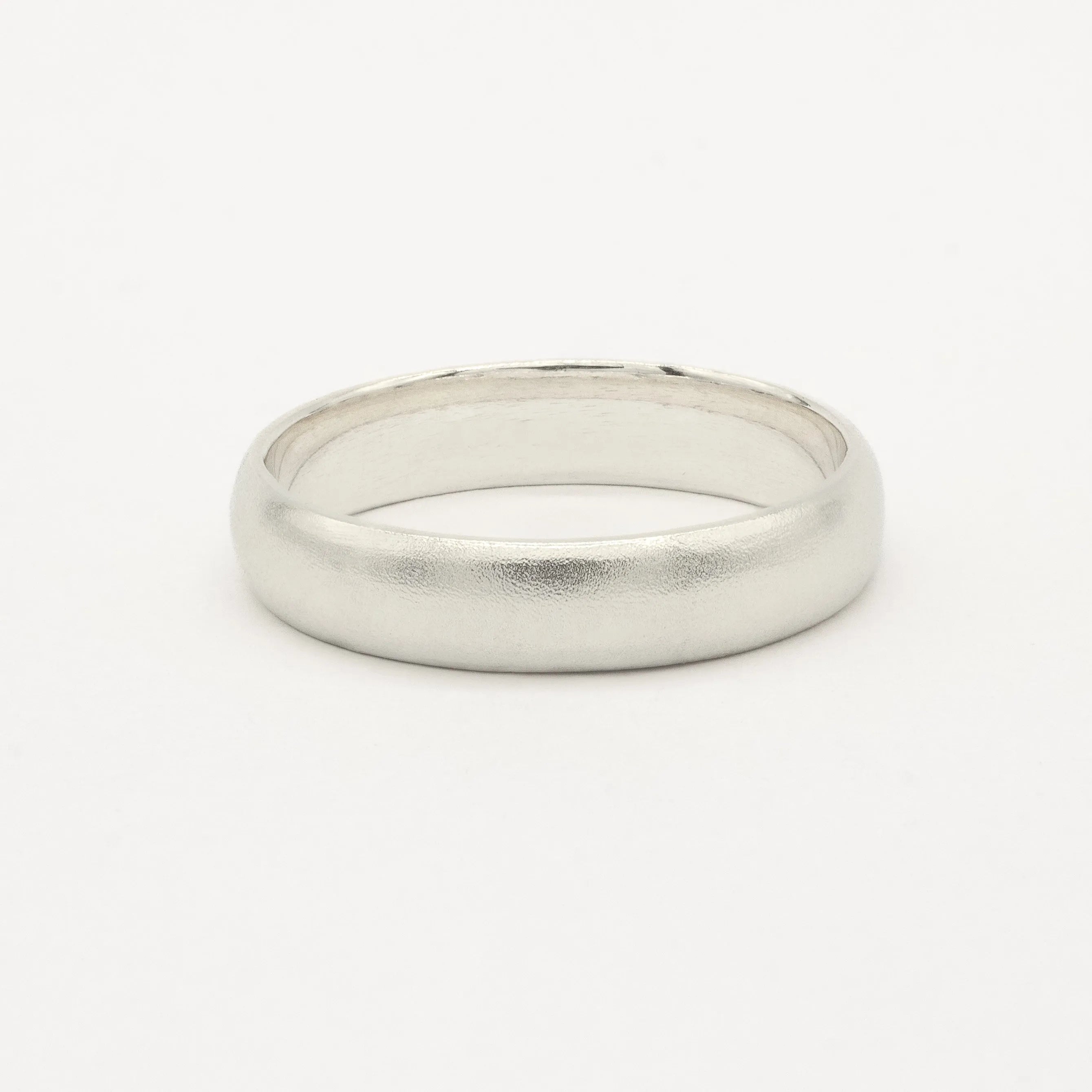White gold satin wedding ring on a white background
