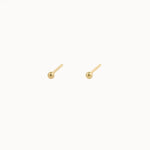 Pair of gold stud earrings on a white background
