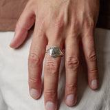 close up of male hand wearing silver full moon ring on middle finger
