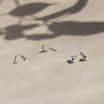 triangle, bar and pebble silver stud earrings with leaf shadow