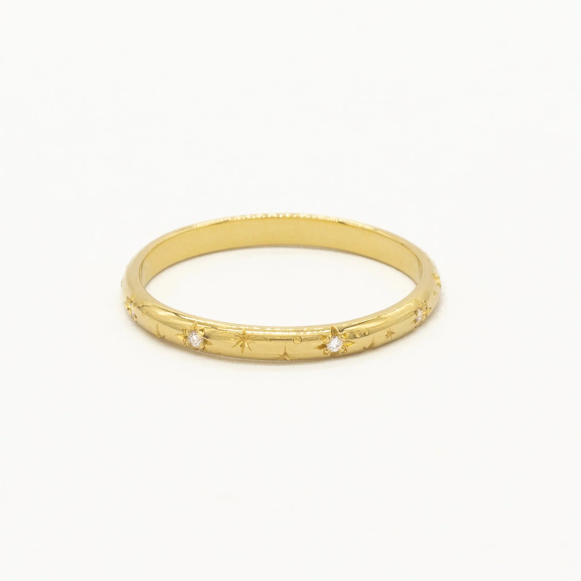 cut out of yellow gold wedding ring with star engraving and small round diamonds and shadow