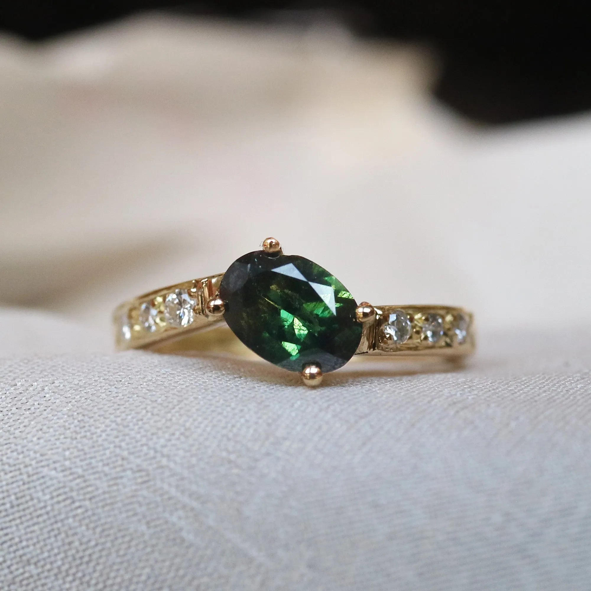 diamond alternative engagement ring featuring green sapphire stone