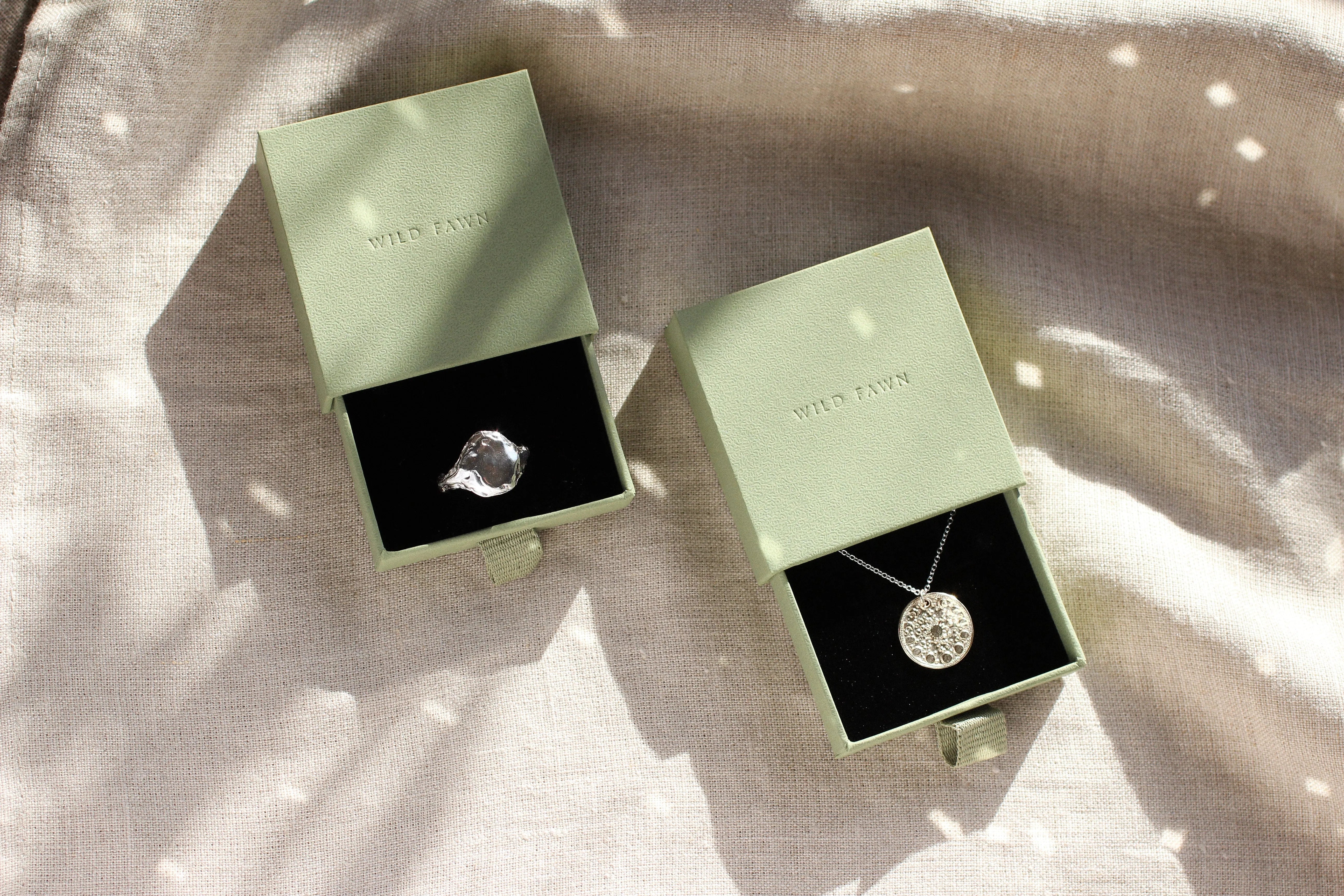 three pairs of gold stud earrings in jewellery set with leaf shadow