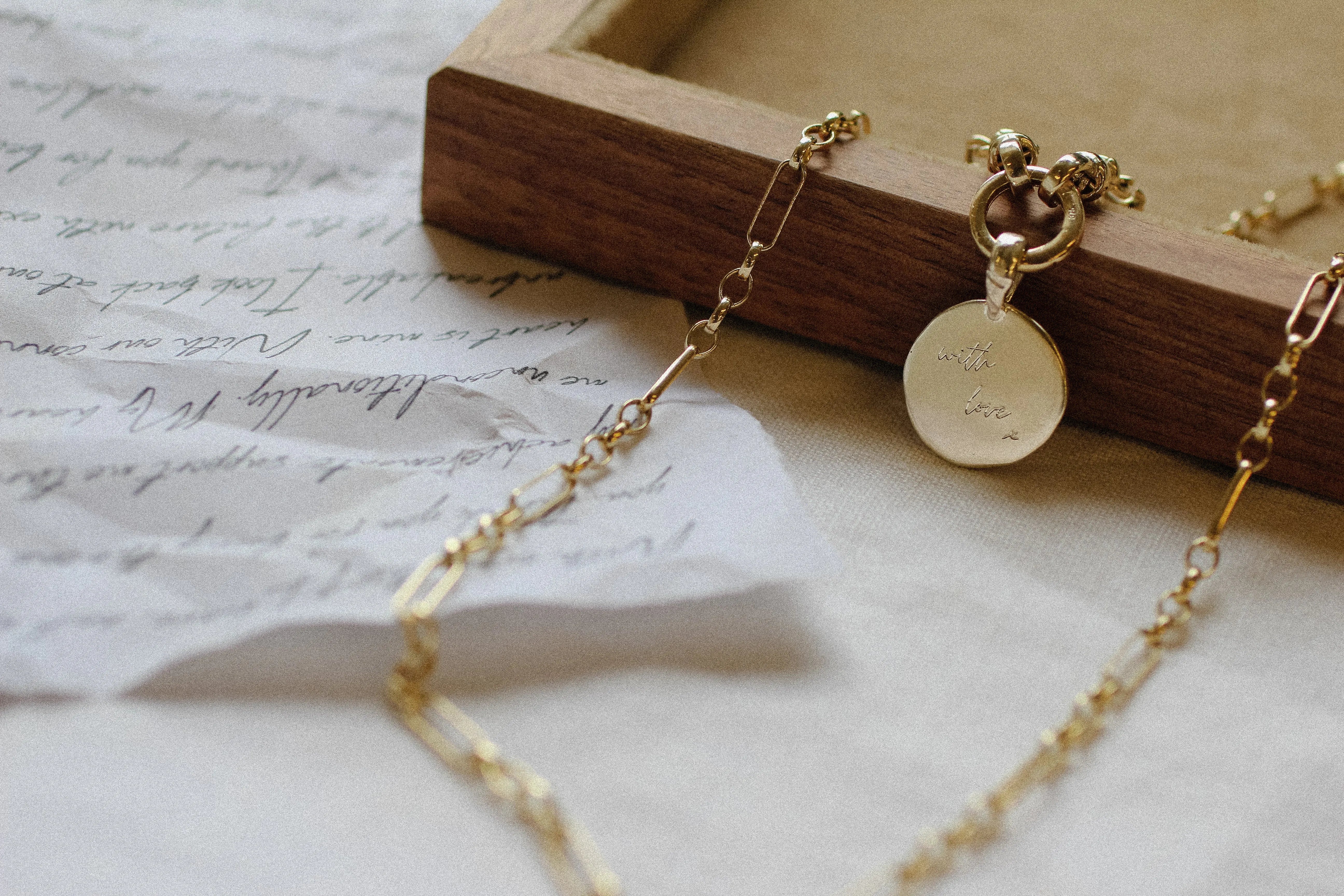 14 engagement rings with blue and green stones and diamonds on marble surface