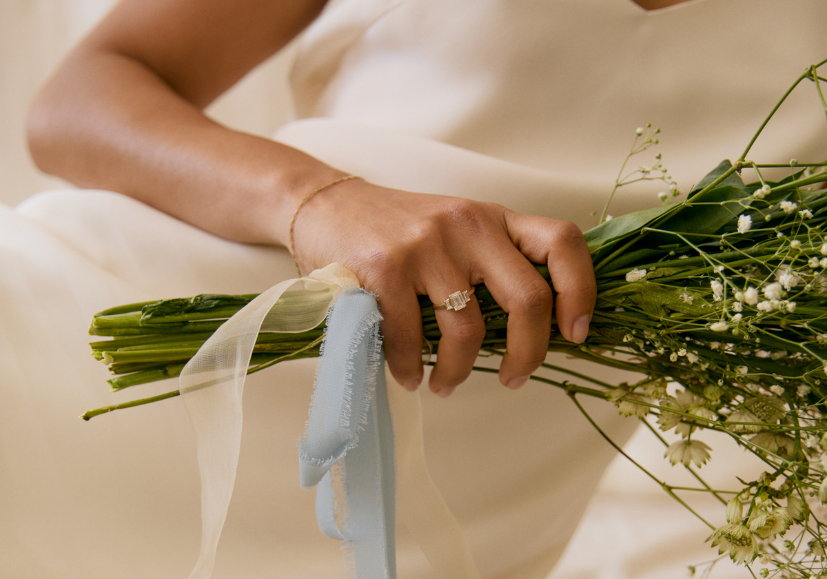 Person holding a bouquet of flowers with a soft focus background