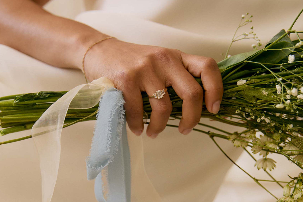 Person holding a bouquet of flowers with a soft focus background