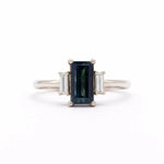 18ct White Gold Blue Sapphire Baguette Three Stone Engagement Ring on a white backdrop