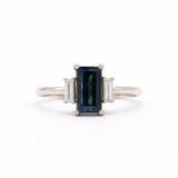 18ct White Gold Blue Sapphire Baguette Three Stone Engagement Ring on a white backdrop