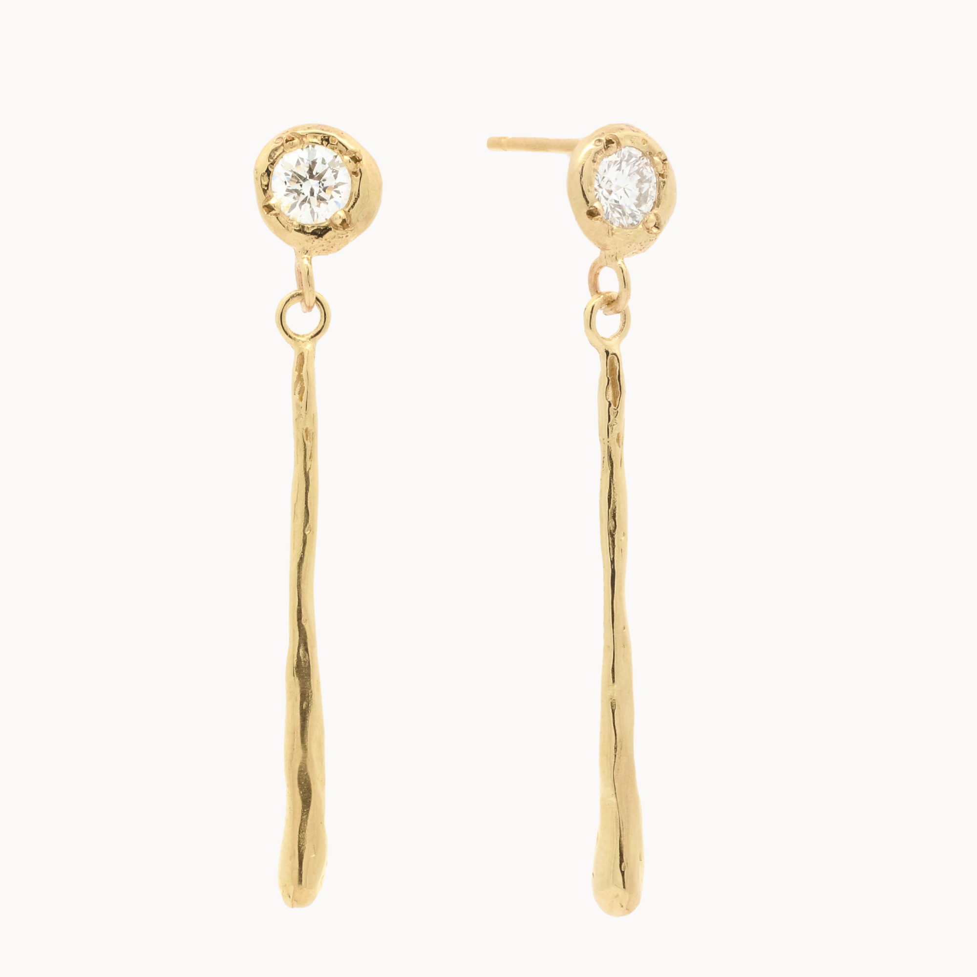 Gold earrings with round diamond studs and molten thin gold bars on a white background