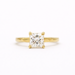gold engagement ring with square princess cut diamond and textured flat band on a white background