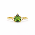 Green Pear Sapphire With Diamond Cluster Detail Engagement Ring on a white background
