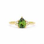 Green Pear Sapphire With Diamond Cluster Detail Engagement Ring on a white background