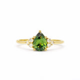 Green Pear Sapphire With Diamond Cluster Detail Engagement Ring on a white background