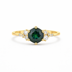 Gold ring with a green gemstone and diamond accents on a white background