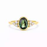 Bezel Oval Green Sapphire Diamond Cluster Engagement Ring on a white background