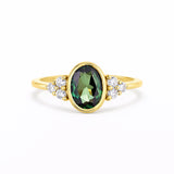 Bezel Oval Green Sapphire Diamond Cluster Engagement Ring on a white background