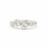 diamond ring in white gold with bezel set round and pear shaped diamonds on a white background