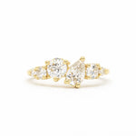 18ct yellow gold cluster engagement ring with round and pear diamonds on a white background