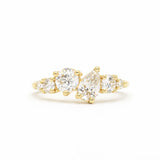18ct yellow gold cluster engagement ring with round and pear diamonds on a white background