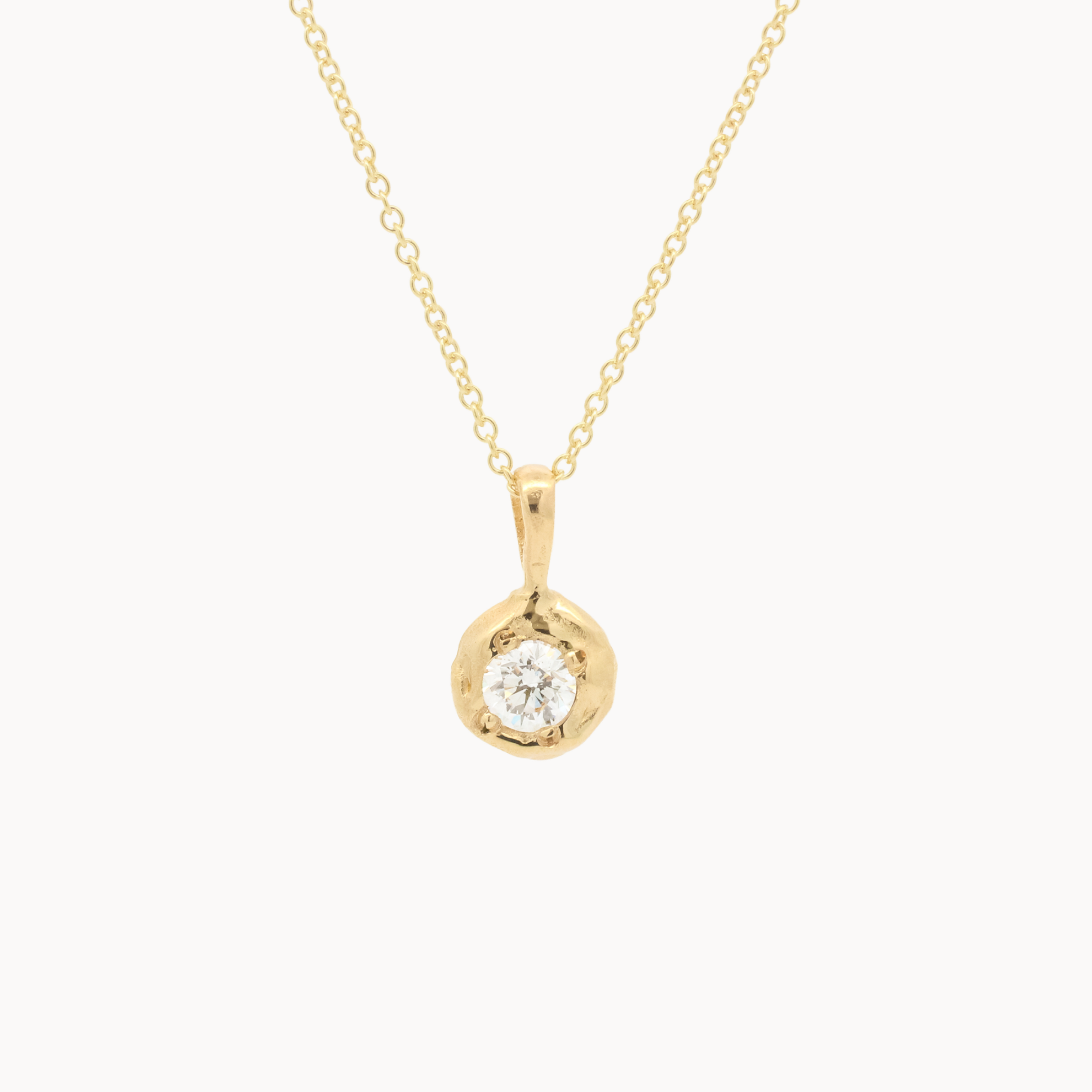 yellow gold necklace with round molten-effect pendant and round diamond on a white background