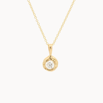 yellow gold necklace with round molten-effect pendant and round diamond on a white background
