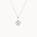 white gold pendant necklace with molten-effect gold and round diamond on a white background