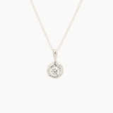 white gold pendant necklace with molten-effect gold and round diamond on a white background