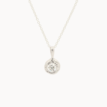 white gold pendant necklace with molten-effect gold and round diamond on a white background