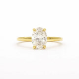 oval diamond solitatire engagement ring with solid gold band on a white background
