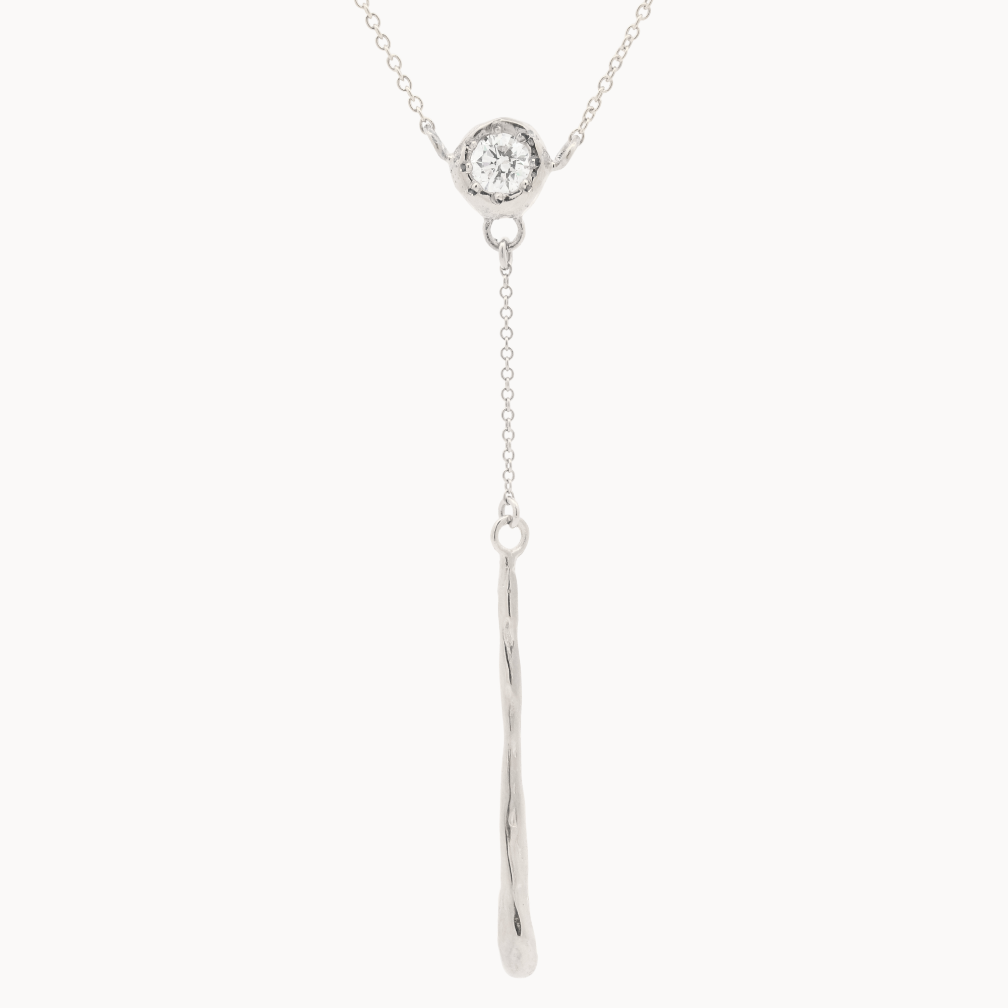 white gold y-shaped necklace with round molten diamond pendant and molten bar hanging from a chain on a white background 