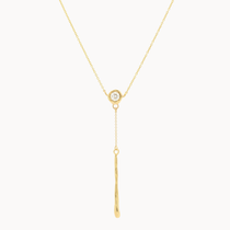 gold y-shape necklace with round diamond and long molten bar hanging pendant on a white background