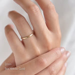 hand wearing slim 2mm dainty hammered wedding ring in 9ct yellow gold