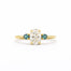 Gold ring with a central diamond flanked by two smaller diamonds on a white background