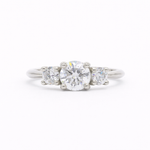 Trilogy round Diamond White Gold Engagement Ring on a white background