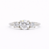Trilogy round Diamond White Gold Engagement Ring on a white background