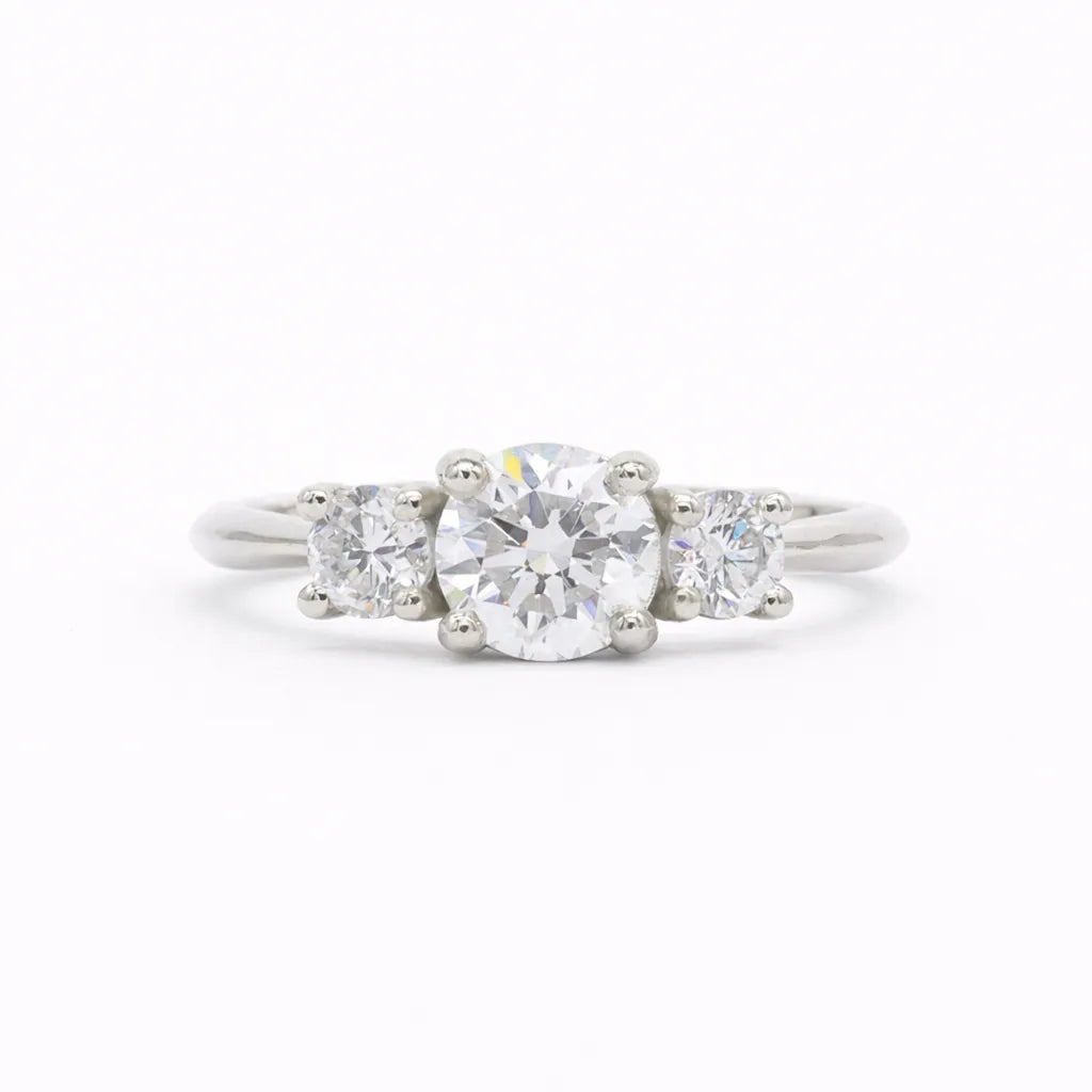 Trilogy round Diamond White Gold Engagement Ring on a white background