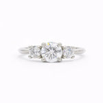 Trilogy round Diamond White Gold Engagement Ring on a white background