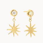 gold diamond dangle earrings with molten texture and sun-shaped charms on a white background
