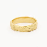 A textured gold band ring with a hammered, organic surface finish, photographed on a clean white background.