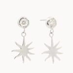 White gold diamond stud earrings with sun-shaped charms hanging off them against a white background