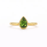 Bezel Green Pear Sapphire Solitaire Engagement Ring in gold on a white background