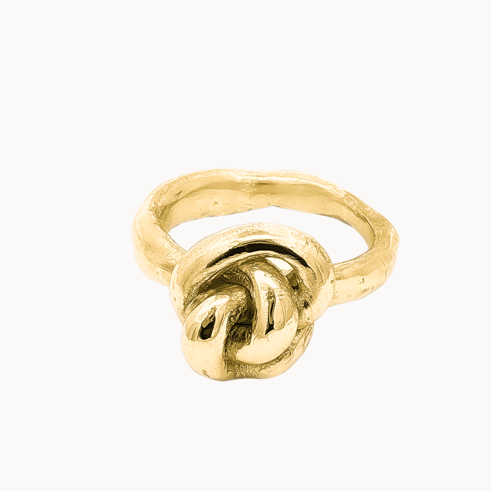 A textured gold ring featuring a knotted design on the front, photographed against a solid off-white background.