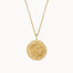 Gold compass necklace with a engraved pendant on a white background