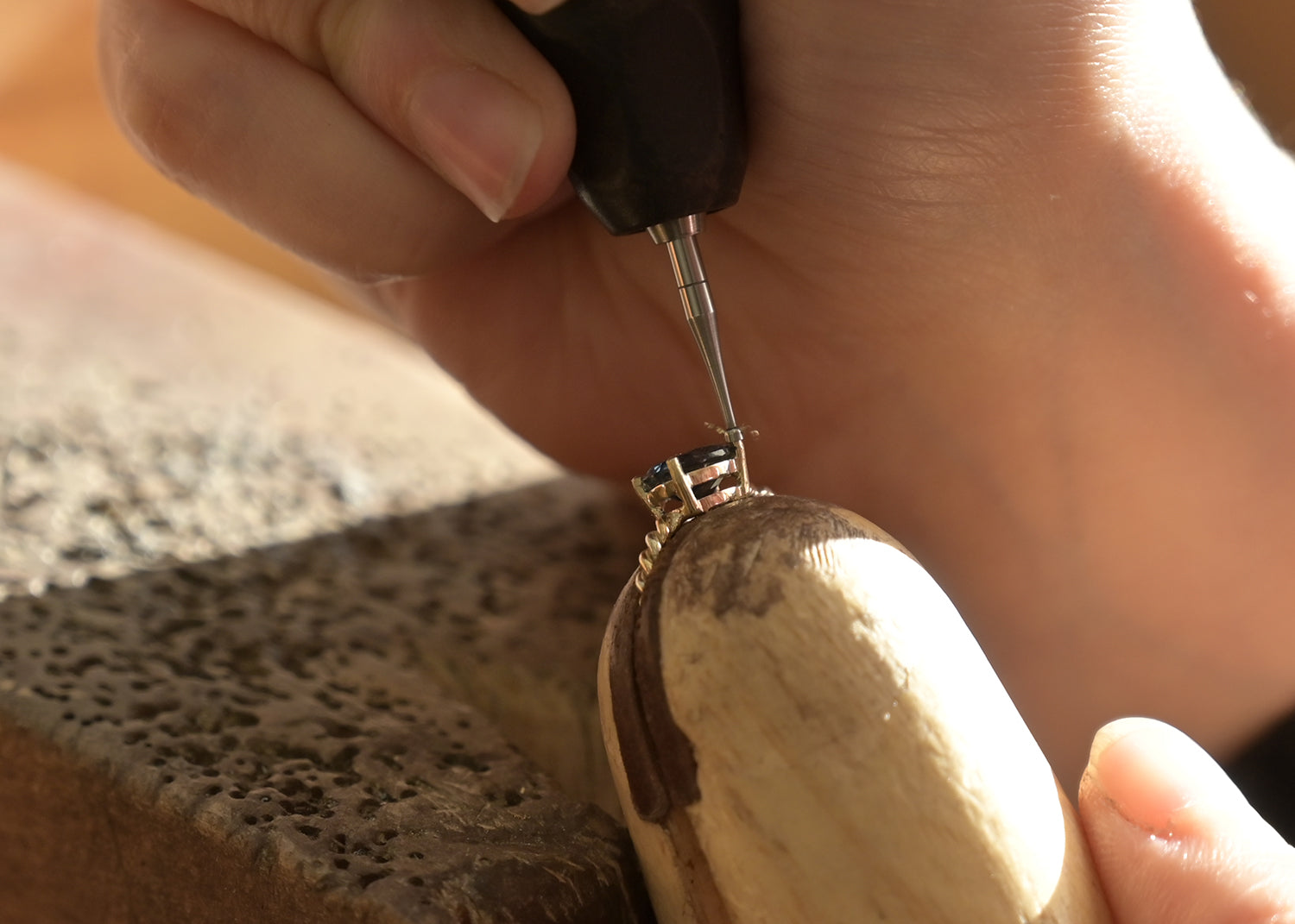 engagement ring having it's stone set on a jewellery work bench
