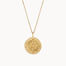 Gold necklace with a round compass pendant on a white background