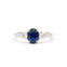 white gold engagement ring with a blue sapphire and two smaller diamonds on a white background