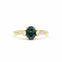 Gold engagement with a blue sapphire and tapered smaller diamonds on a white background