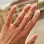 Hand wearing a ring with a blurred background