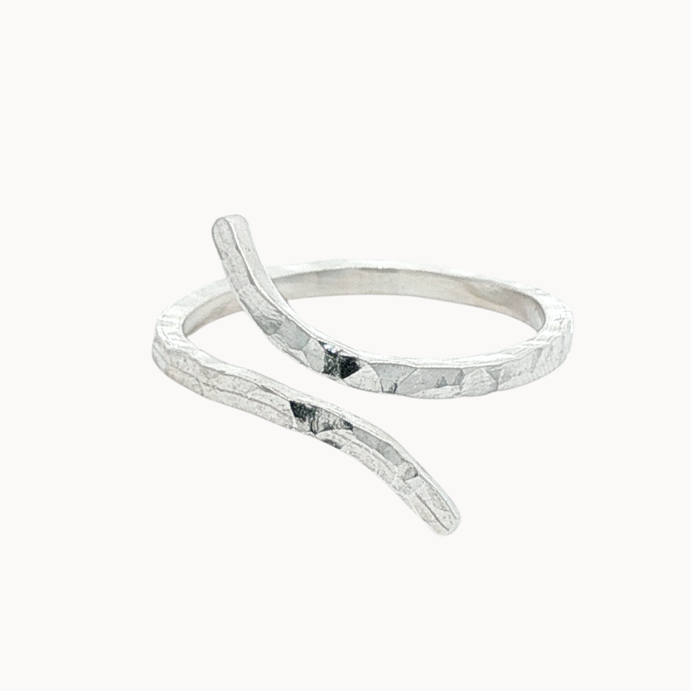silver hammered ring with unique open shape on a white background